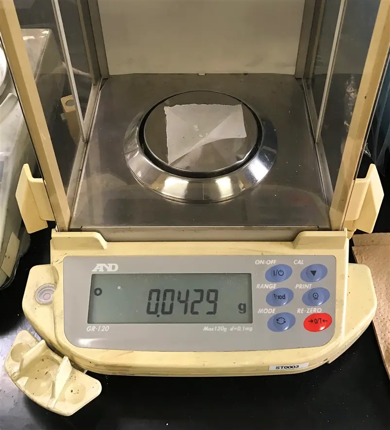 Fig. 4 Preparation of 0.1 mol/L Silver I nitrate in TBAP/ACN solution. Weigh 0.043 g silver I nitrate using an analytical digital balance and medicine wrapping paper. After weighing transfer AgNO3 from the medicine wrapping paper to another 50 mL beaker and add a small amount of the 0.1 M TBAP/ACN solution prepared earlier to dissolve the AgNO3.